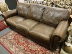 A Barker and Stonehouse Natuzzi brown leather three seater settee,