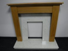An oak fire surround with marble hearth and back