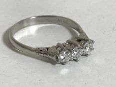 A platinum three stone diamond ring