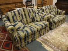 A Chapmans three piece lounge suite comprising of three seater and a pair of two seater settees,
