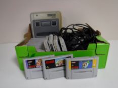 A box of Super Nintendo with leads and accessories and a Game Boy Color