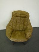 A mid 20th century brown leather swivel armchair on chrome base