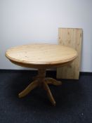 A circular pine pedestal kitchen table,