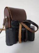 A set of leather cased Carl Zeiss Jenoptem 8x30 binoculars