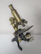 An antique brass microscope by J.