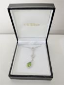 A 9ct white gold diamond and peridot pendant on chain, 3.