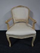 A beech framed armchair in peach upholstery