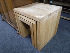 A nest of three contemporary oak tables
