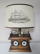 A contemporary mahogany ship's style table lamp with shade depicting a clipper,