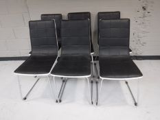 A set of six contemporary black leather dining chairs with chrome legs