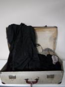 A vintage case containing Victorian clothing,