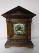 An early twentieth century carved oak cased bracket clock
