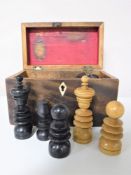A 19th century mahogany box containing a turned ebony and boxwood chess set