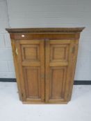 A Victorian oak double door hanging corner cabinet