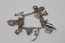 A silver charm bracelet with padlock clasp