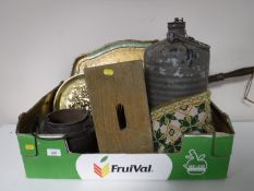 A box containing serving trays, cracket, metal canister,