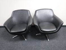 A pair of mid twentieth century black vinyl armchairs on chrome bases