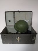 A military footlocker containing boots, helmet,