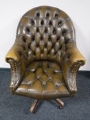A Chesterfield button back tan leather swivel desk chair