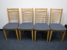 A set of four contemporary oak ladder back dining chairs