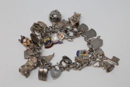 A silver charm bracelet with padlock clasp