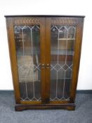 An oak leaded double door display cabinet