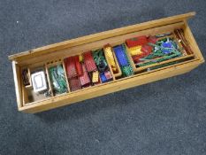 A large wooden storage box containing a quantity of mid twentieth century Meccano