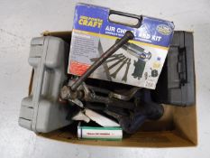 A heavy duty bench vice, together with a box containing air compressor tool kits,