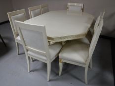 An octagonal pedestal dining table and eight chairs