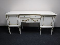 A white and gilt Regency style inverted breakfront sideboard