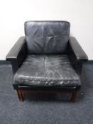 A mid twentieth century Danish black leather armchair