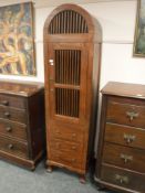 A contemporary domed shutter door cabinet,