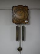 A walnut cased wall clock with pendulum and weights