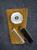 A wall barometer with brush set