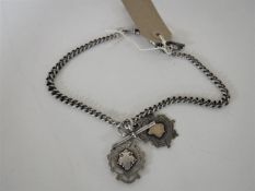 A silver Albert chain with T-bars and two fobs