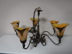 A brass five way light fitting with glass shades