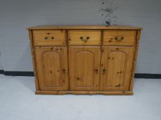 A pine triple door sideboard
