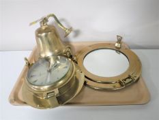 A quartz ships time ship's style clock together with a ship's bell and porthole mirror