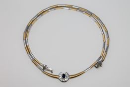An 18ct white and yellow gold diamond and sapphire set necklace,