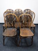 A set of eight oak wheel back dining chairs