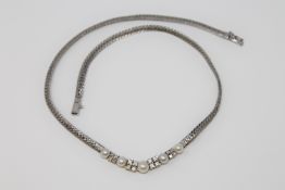 An 18ct white gold necklace set with pearls and diamonds, approximately 0.9ct. 28.