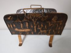 A copper embossed magazine rack of African design