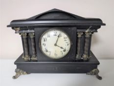 An Edwardian mantel clock with enamelled dial and key