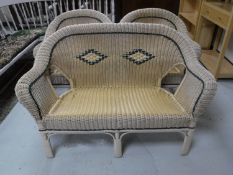 A three piece wicker conservatory suite