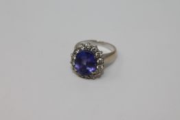 An 18ct white gold tanzanite diamond cluster ring, size L/M.
