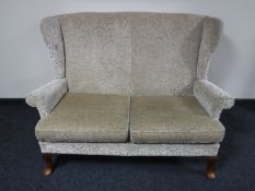 A Parker Knoll wingback two seater settee