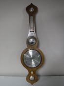A walnut cased barometer with silvered dial