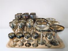 Two trays containing a large quantity of plated goblets together with five plated trophies on