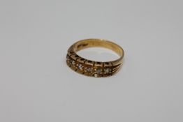 An 18ct gold six stone diamond ring, size P/Q, 4.5g.