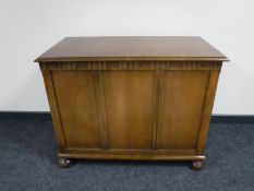 An oak blanket box on bun feet